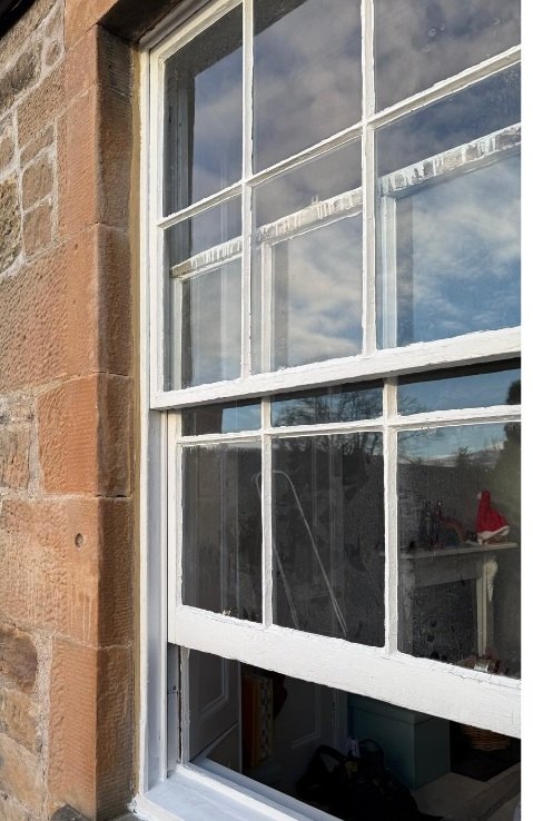 Traditional timber sash and case window undergoing repair